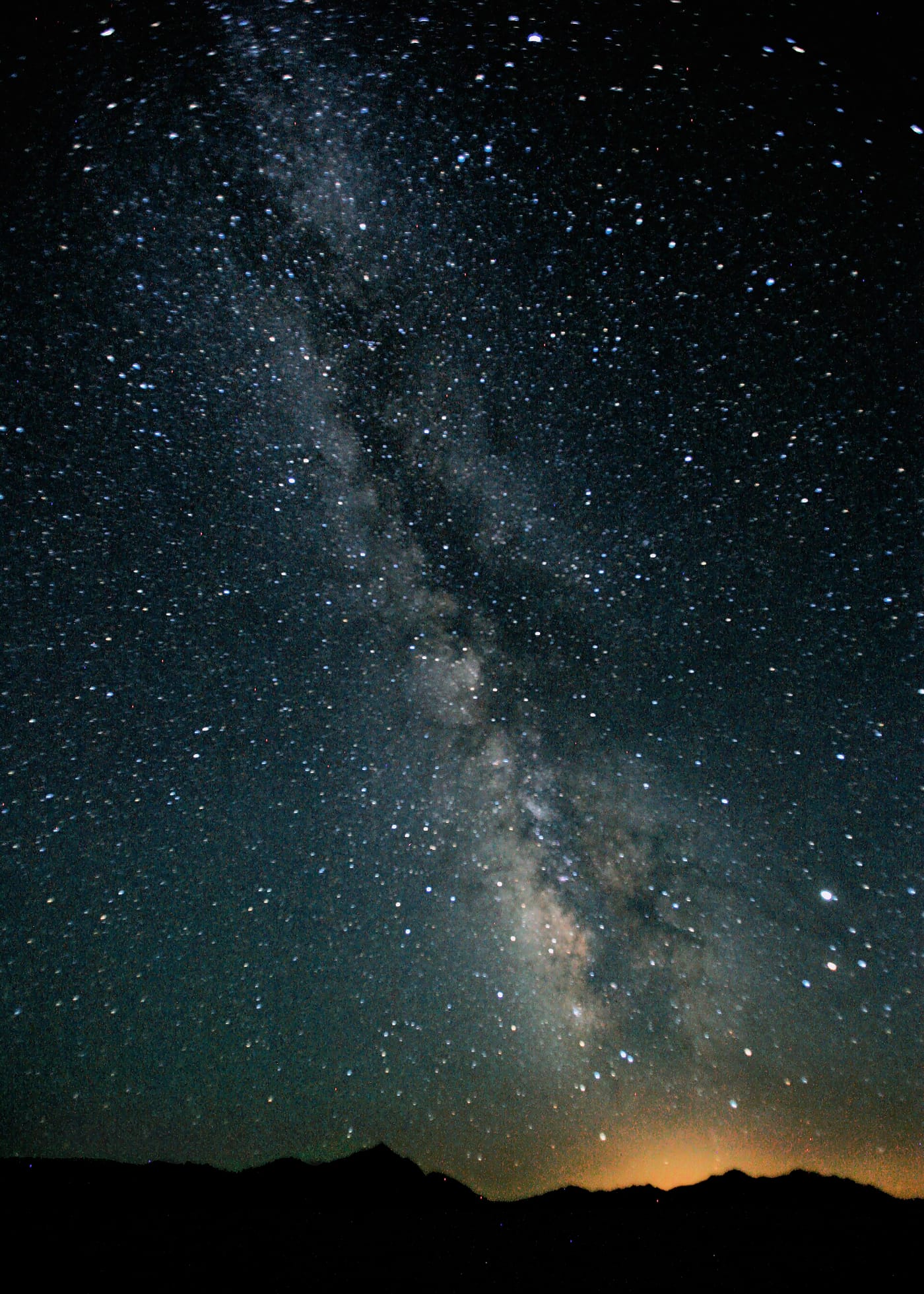 Bedouin camp at night in the Sinai desert near Sharm El Sheikh with a fire, low seating and a sky full of stars